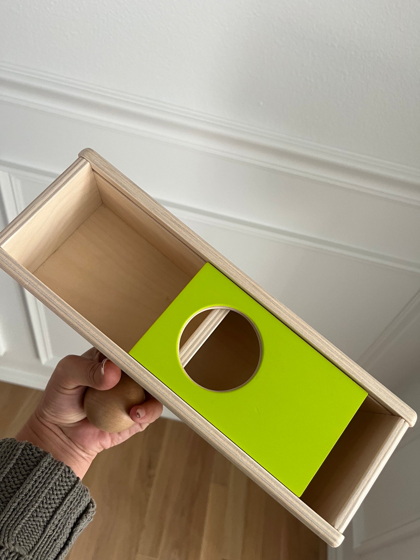 Lovevery sliding top box with one wooden ball